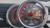 Close-up view of a Mini John Cooper Works convertible's dashboard. The image shows two circular dials, the left one displaying the fuel gauge and part of the tachometer, and the right one showing the speedometer (in mph and km/h), various warning lights, and an odometer reading 27,044 miles and 2,343.9 miles on the trip meter.
