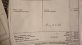 A close-up photo of an invoice from John Tite Car Repairs Ltd. The bill, dated June 3, 2020, includes details such as the customer's name, invoice number, and costs for clutch kit and flywheel repairs on a MINI. Handwritten notes and calculations are visible on the page.