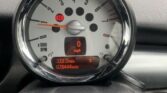 A MINI speedometer and tachometer display a speed of 0 mph and engine revolutions per minute up to 7,000 RPM. Below, an LCD shows the odometer at 78,444 miles, a trip distance of 322.2 miles, and a fuel gauge indicating low fuel with an orange warning light.