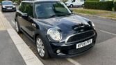 This black Mini Cooper S is a stylish and sporty 3-door hatchback with manual transmission and right-hand drive. With a powerful 111-185 kW engine