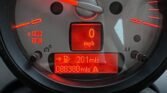 Close-up of a MINI's illuminated analog speedometer and digital display. The speedometer is marked from 0 to 8 x 1000 RPM, with the needle at 0. The digital display shows "0 mph," "201 mls," and the odometer reading "088380 mls." A warning indicator and fuel gauge are also visible.