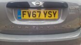 The rear view of a grey MINI Countryman Cooper D car is shown, featuring a European Union 'GB' license plate with registration number "FV67 YSY". The MINI logo is positioned above the plate, and the car emblem badges "COOPER D" and "COUNTRYMAN" appear on the trunk.