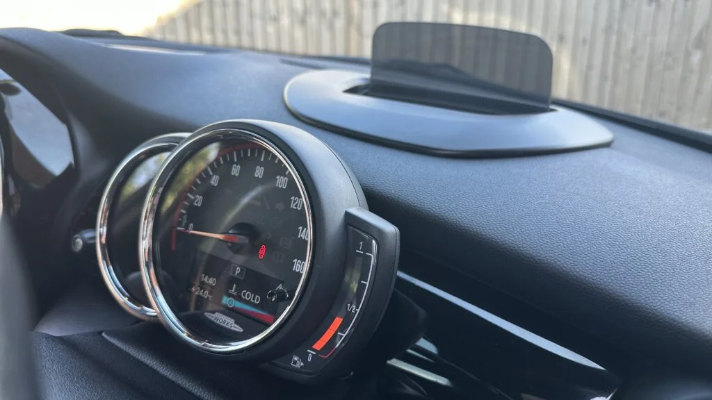 The dashboard and instrument cluster of a MINI Cooper, where you check the mileage on a high mileage MINI Cooper